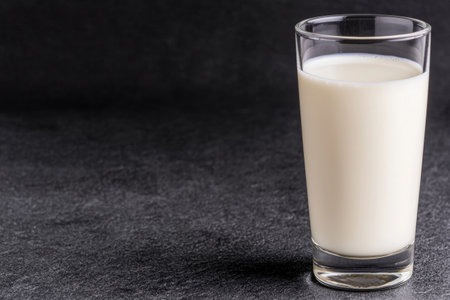 glass of fresh milk on dark backgroundの素材