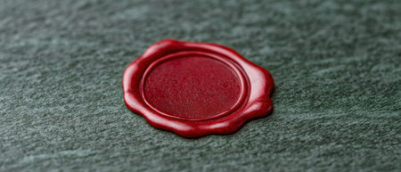 Vintage red wax seal on green fabricの素材