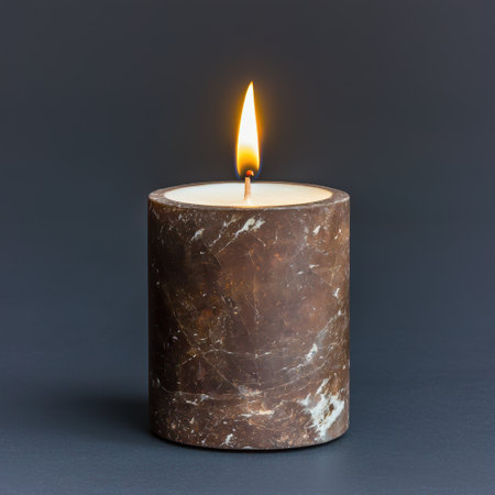 Burning candle in a marble holderの素材