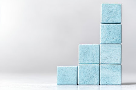 Stacked blue concrete cubes on white backgroundの素材