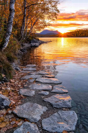 Scenic autumn sunset over a tranquil lakeの素材