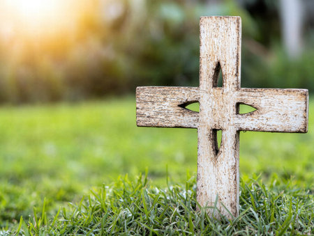 Wooden cross in grassy fieldの素材