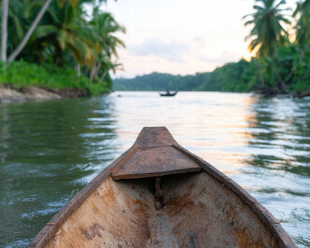 Serene tropical river scene with wooden boatの素材