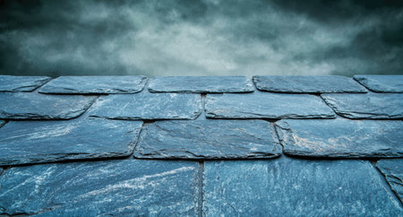 Dramatic stormy sky over a slate roofの素材