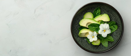 Avocado slices with spinach and pansies on a dark plateの素材
