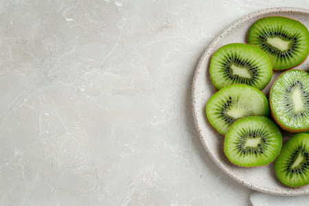 Close-up of sliced kiwi fruit on a plateの素材