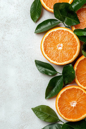 Fresh orange slices with green leaves on white backgroundの素材
