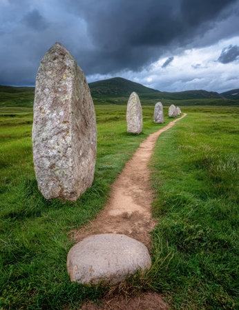 Stone path leading to ancient standing stones under a dramatic skyの素材