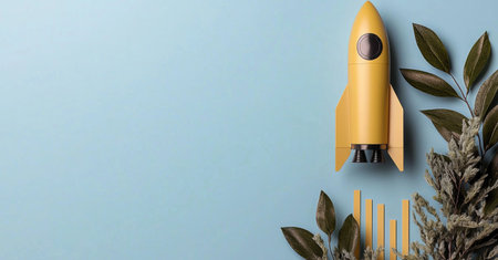 Yellow rocket launching with gold bar graph and leaves on blue backgroundの素材
