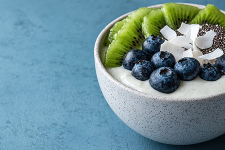 Healthy breakfast parfait with yogurt, kiwi, blueberries, chia seeds, and coconut flakesの素材