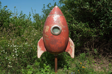 Rustic red rocket ship in a field of wildflowersの素材