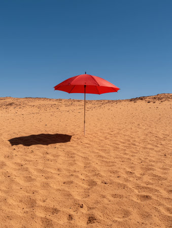 Red umbrella in a desert landscapeの素材