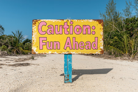 Caution: Fun Ahead - A rustic beach sign points the way to summer adventures.の素材