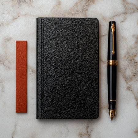 Black leather notebook, fountain pen, and bookmark on marble backgroundの素材