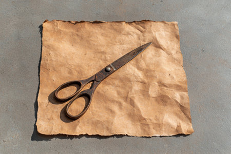 Rusty scissors on crumpled brown paperの素材