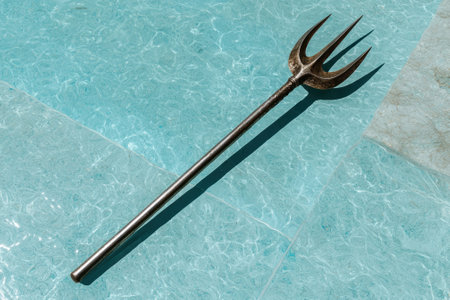 Ancient trident on blue marble backgroundの素材