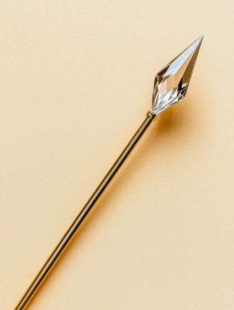 Gold wand with crystal tip on beige backgroundの素材