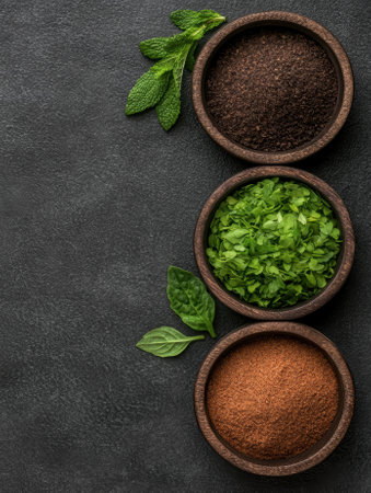 Three bowls of different herbs and spices on a dark backgroundの素材