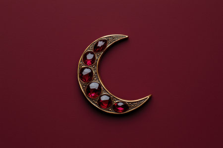 Crescent moon with red gemstones on dark red backgroundの素材