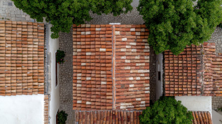 Aerial view of terracotta roof tiles on housesの素材