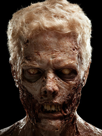 A terrifying zombie with decaying flesh stares intensely.の素材