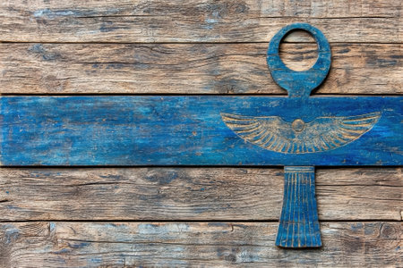 Ancient Egyptian ankh symbol on a wooden background.の素材