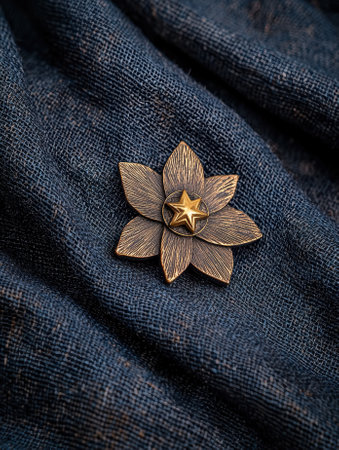 Elegant flower brooch on textured fabric.の素材