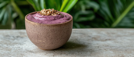 A purple smoothie bowl with granola topping.の素材