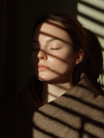 Woman with closed eyes in sunlightの素材