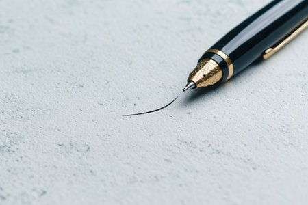Close-up of a fountain pen drawing a line on paper.の素材