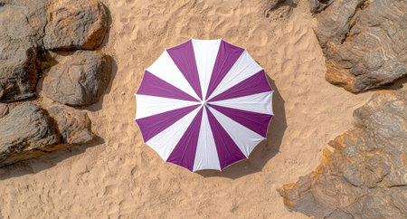 Purple and white beach umbrella on a sandy beach.の素材
