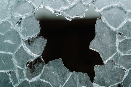 Broken glass with a hole in the middle.の素材