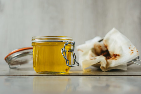 clarified liquid ghee butter in glass jarの写真素材