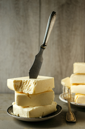 stack of butter blocks with knife on topの写真素材
