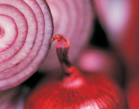 Fresh circles of raw onions with whole product close-up, organic agricultural crop from vegetable...