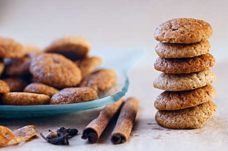 Baked traditional seasonal round ginger cookies with cloves and cinnamon aroma on plate and in stackの写真素材