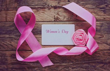 background with a pink silk ribbon, International Women's Dayの写真素材