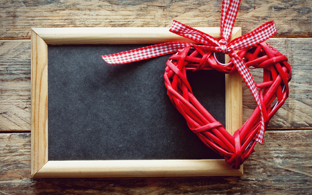 Valentine's day background with braided heart, black board, old board wall, retro styleの写真素材