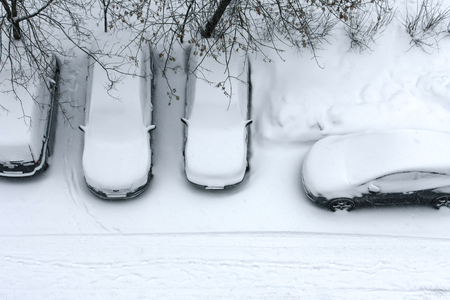 cars in snow, stand in row, top view of street, winter cityscapeの写真素材