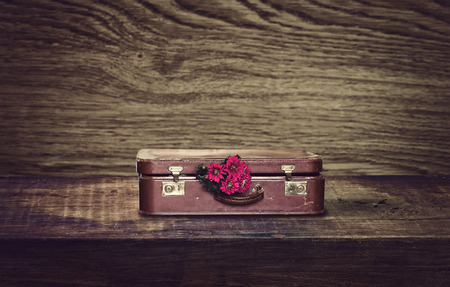 old suitcase with a bouquet of chrysanthemumsの写真素材