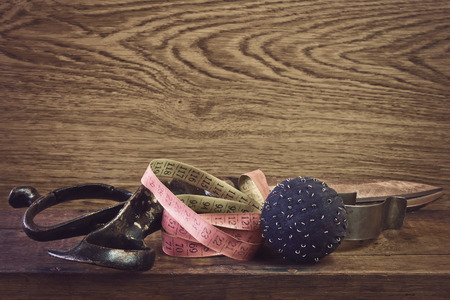 old big scissors, pin cushion and measuring tapeの写真素材