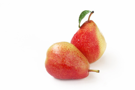 Two wet sweet ripe red pears on white backgroundの写真素材