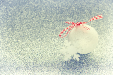 Christmas sparkling background, white ball bauble, snowflake, new year compositionの写真素材