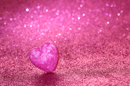 Valentine's day pink glitter background with shiny heart, selective focusの写真素材