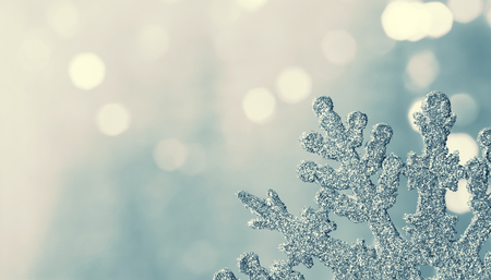 Christmas background with silver snowflake close upの写真素材