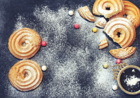 March 8, International Women's Day, homemade cookies sprinkled with sugar powder, candy pills on a black tableの写真素材