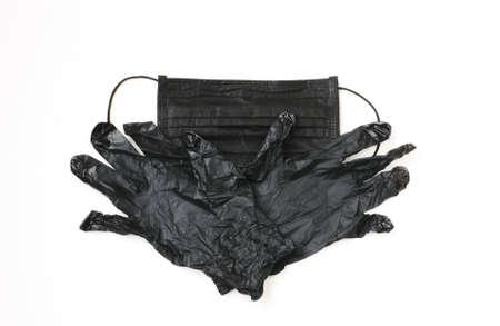 personal virus protection, black rubber disposable gloves and medical mask on white background