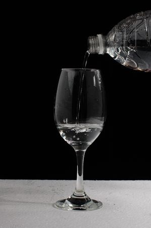 pouring water in wineglassの写真素材