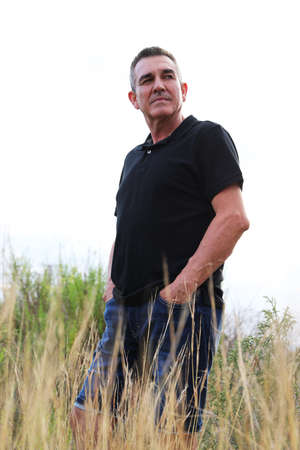 Handsome and healthy man who takes care of himself is 60 years old, in a field in Alicanteの写真素材
