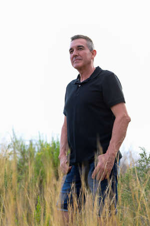 Handsome and healthy man who takes care of himself is 60 years old, in a field in Alicanteの写真素材